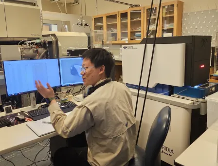Graduate student Xuanyu Liu demonstrates the femtosecond laser system in the isotope cosmochemistry lab.