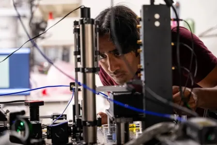 A student works with quantum-sensing equipment in Chong Zu's lab.
