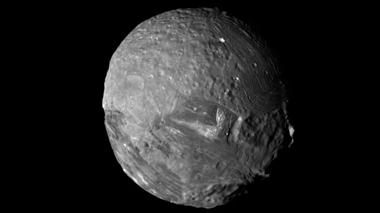 Unique geologic features on Uranus’ moon Miranda (seen here in a photo taken by Voyager 2 in 1986) may have been created by thinning of the moon’s icy shell.  Kevin M. Gill/JPL/NASA