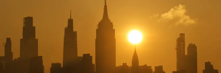 The sun rises over New York City as a heat wave arrives in June 2025. Gary Hershorn/Getty Images